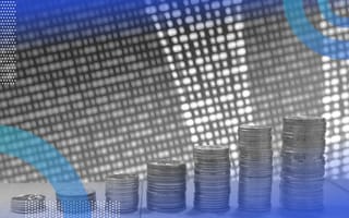 Stacks of coins in front of a data scroll