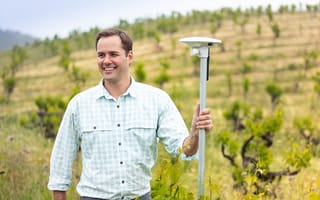 Arable CEO Jim Ethington next to his company's sensors in a field.