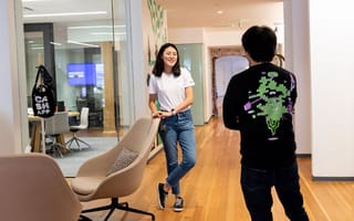 Two Cash App team members having a conversation in the office