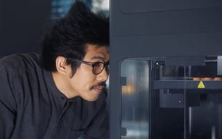 Markforged team member working with a 3D printer