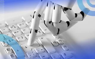 An articulated robot hand presses a return key on a keyboard with one finger. /robotics/software-revolution-robotics
