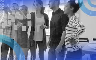 A group of people work at a kanban board