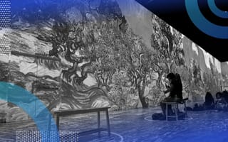 Two people sit on a bench and experience the Van Gogh immersive art exhibit. /blockchain/exhibiting-nft-digital-art