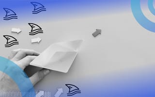 A hand pushes a paper boat away from drawings of shark fins. Navigating crisis. /marketing/marketers-sales-surviving-downturn