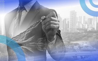 A man in a suit manipulates a digital line graph in front of a city