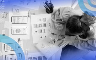 A UI/UX designer works on paper designs