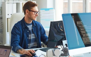 Software developer using computer in office