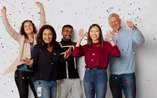 ServiceNow team members throwing confetti in the air