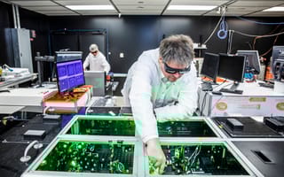 TAU Systems CEO Bjorn Manuel Hegelich aligns laser beams at the University of Texas at Austin.