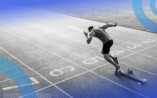 A sprinter launches out of the blocks on a race track
