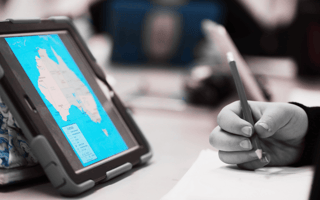 a tablet on.a student desk to represent iot in education