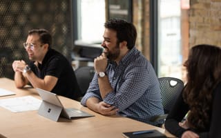 MVMNT team members sit at a table