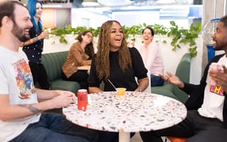 Members of the Core Digital Media team laughing in the lounge at the company's headquarters