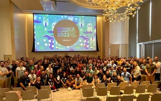 huntress company photo at summit conference, with employees in front of projector