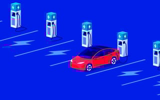 Red electric vehicle charging at an empty charging station.