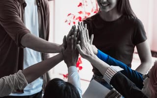 a photo of a group of people high-fiving
