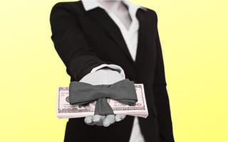 person handing out stack of money