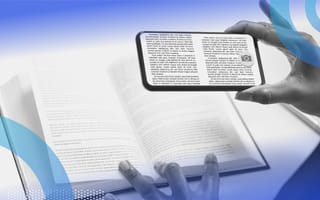 A person using their phone's camera to recognize the characters in a book.