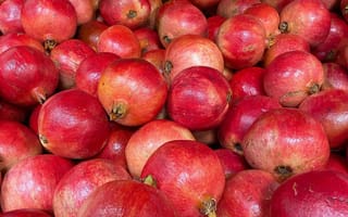 A bin full of pomegranates