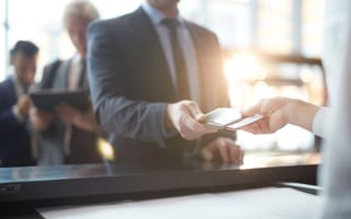 A person shows their passport at the airport.