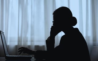 person in shadow making phone call