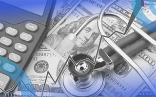 A stethoscope sits atop a pile of money with a calculator and a rising trend line