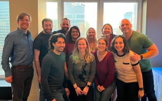 The Frame AI team gathers for a photo indoors.