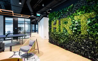 Hudson River Trading's office. On the wall is a hedge with "HRT" on it.