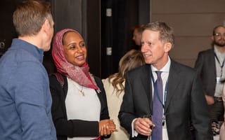 Eventus team members chat at an event.