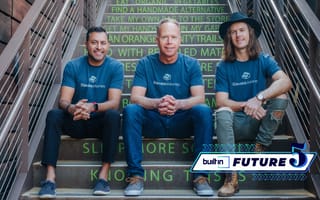 The Elevate.Money founding team sits on a flight of stairs for a photo
