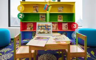 An image of the mini Room to Read library set up at IMC Trading's offices.