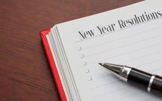 stock image of notebook with new year resolutions written on a page