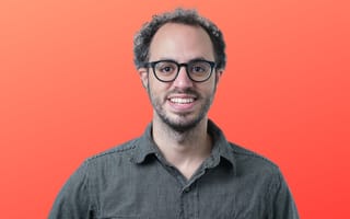 Clerk’s founder and CEO Colin Sidoti poses for a photo against an orange background.