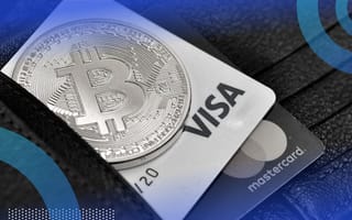 A physical Bitcoin coin and credit cards in a wallet.