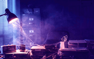 An desk covered in cobwebs left by an absentee employee.