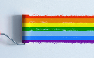 A paint roller painting a rainbow across a blank wall.