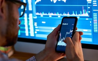 Investor looking over digital currencies on a phone.