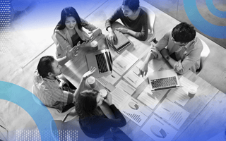 Business Analysis and Reporting group of people meeting and looking over data