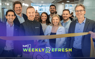 TransLoop employees cut a ribbon at their new office opening