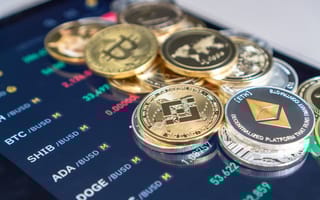 Coins representing crypto currencies placed on a tablet