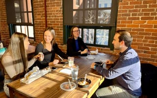 SmarterTravel team members eating lunch together at the office.
