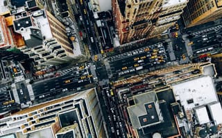An aerial view of NYC skyscrapers and a street intersection.