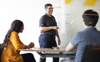 Caterpillar Growth: The E-commerce Team is Building the Future of Customer Service. Here’s How. Members of the Cat Digital team work at a conference room whiteboard