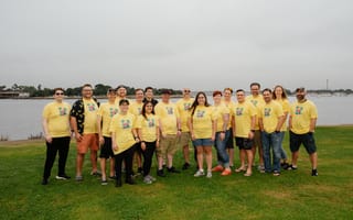 The runZero team poses in matching yellow runZero t-shirts