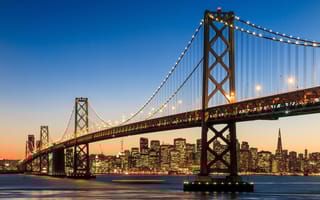 An evening photo of the Golden Gate Bridge and the San Francisco skyline.