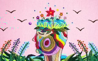 Textile art depicting flowers growing from someone's mind.