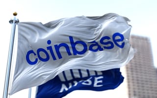 A flag bearing the Coinbase logo flys in front of a flag bearing the logo of the New York Stock Exchange
