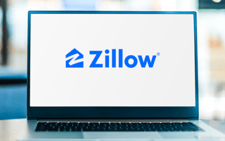 The Zillow logo on an open laptop.