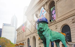 A Chicago monument wearing a Chicago Cubs helmet.