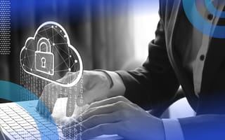 Cloud security image of a person's hands on a laptop keyboard and a hovering cloud with a padlock appearing over the computer.